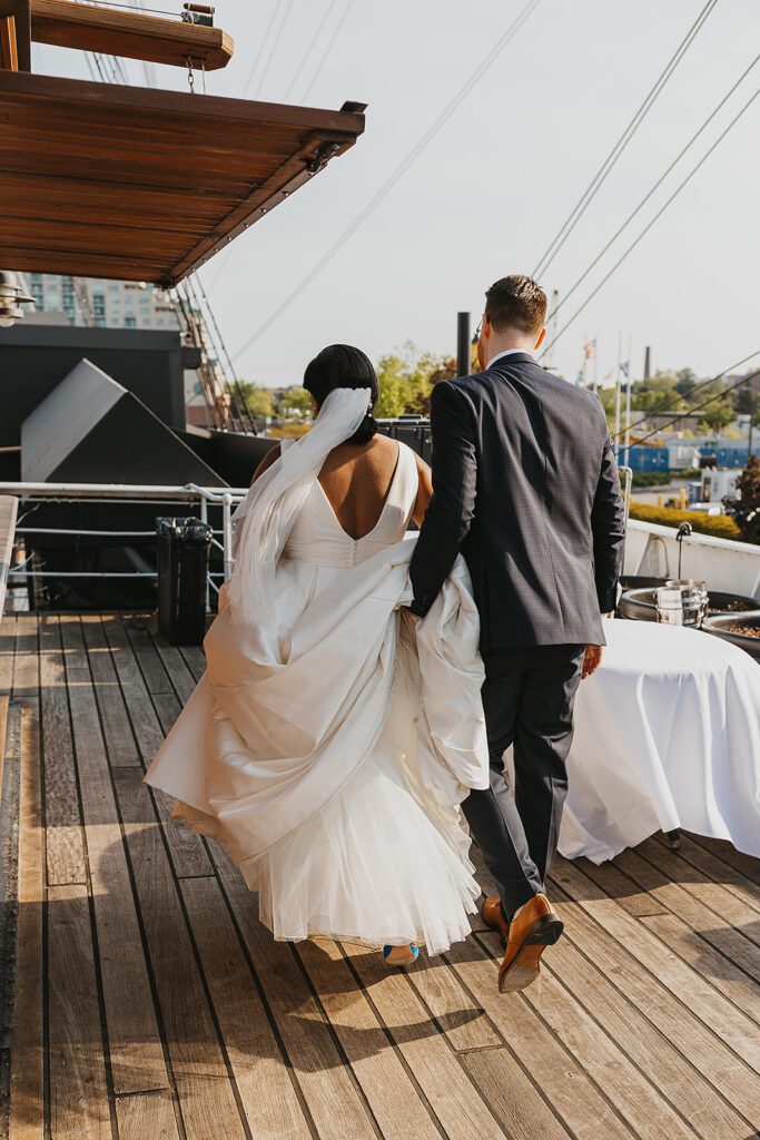 bride and groom roaming Moshulu deck for their boat wedding in Philadelphia