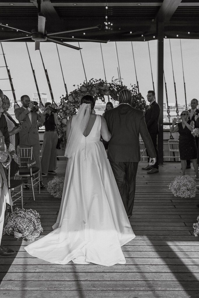 dad walking bride down the aisle on the boat wedding venue