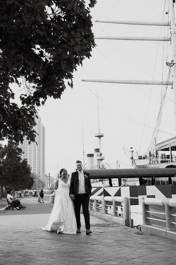 happy bride and groom walking towards their boat wedding venue - Moshulu