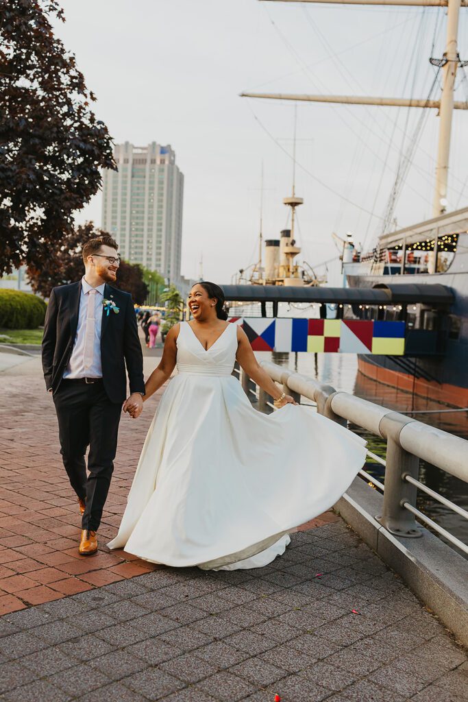 happy bride and groom walking towards their boat wedding venue - Moshulu