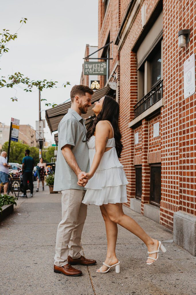 couple walking down the street by Sweet Afton bar