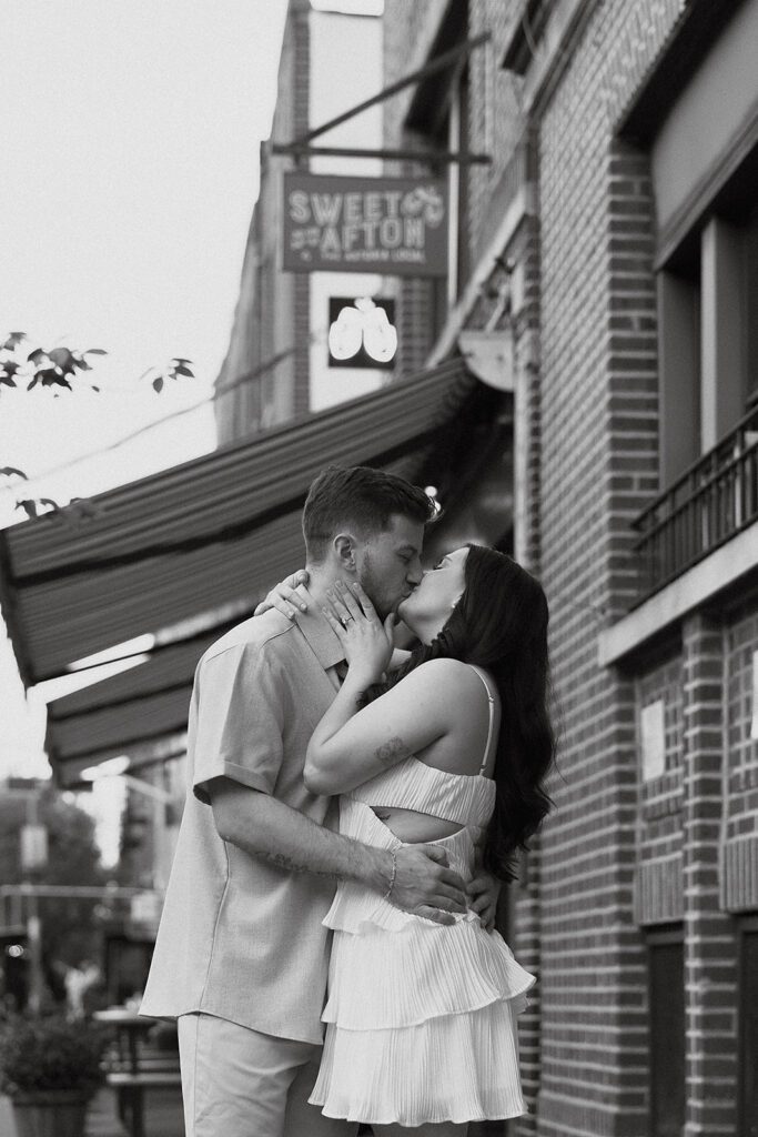 couple walking down the street by Sweet Afton bar