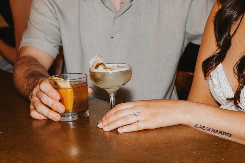 playful couple enjoying drinks in Sweet Afton bar