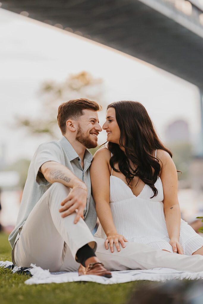 playful engagement photos in Astoria Park