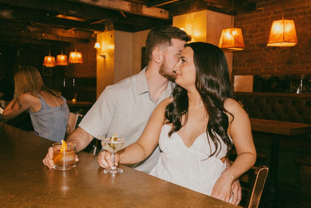 playful couple enjoying drinks in Sweet Afton bar