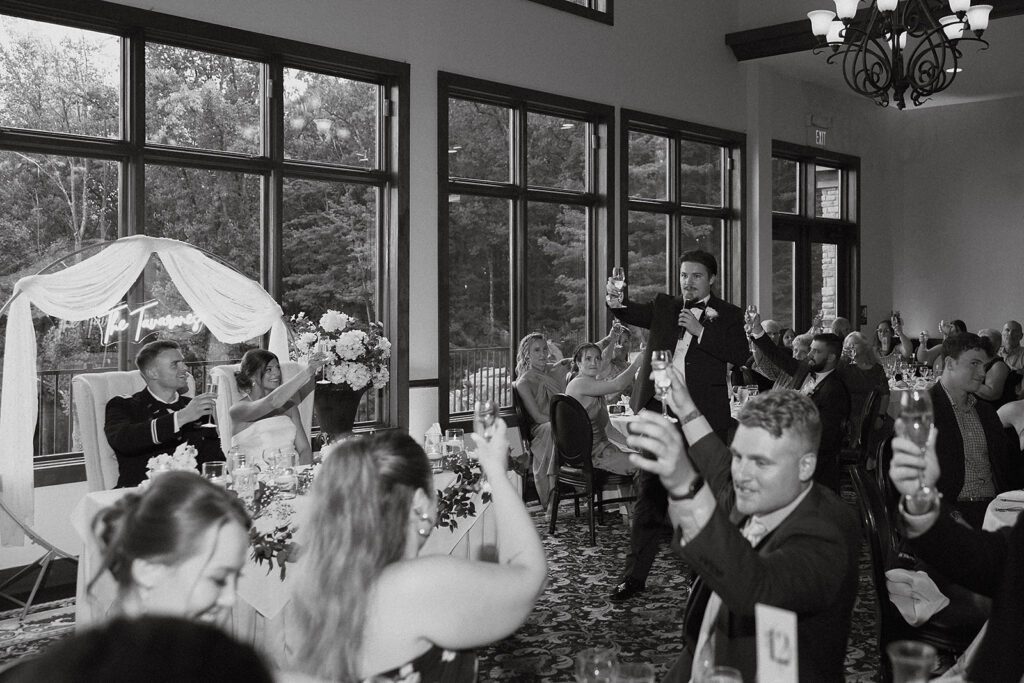 a beautiful wedding reception with guests toasting to the newlyweds