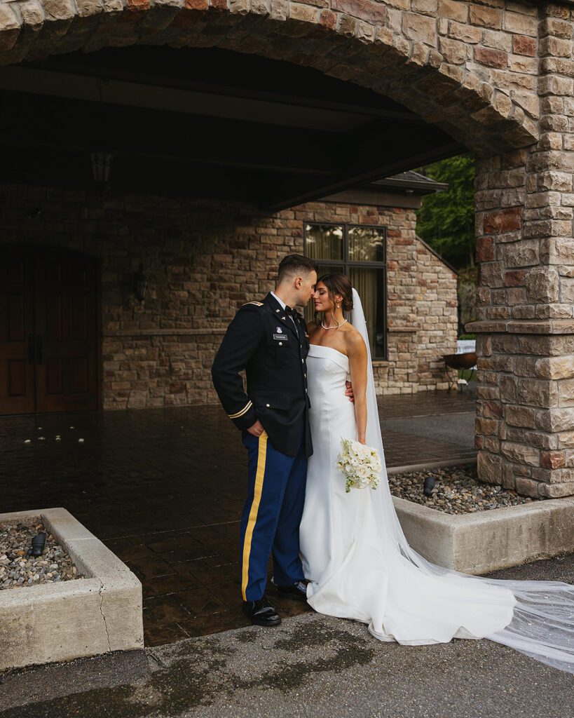 bride and groom posing in front of the venue at Stroudsmoor Country Inn 