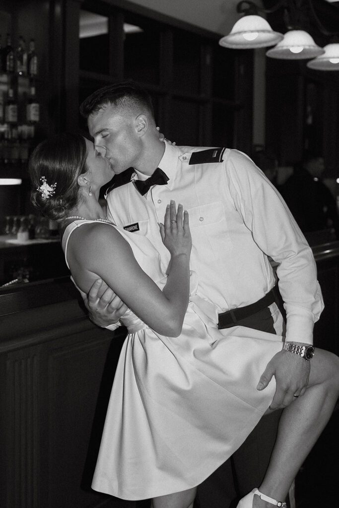 bride and groom kissing in a bar area of the Stroudsmoor Country Inn